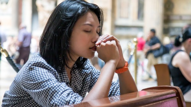 Woman praying in a church